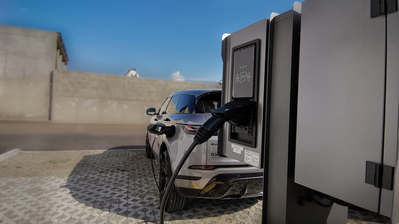 Nahaufnahme eines Hybridautos an einer E-Ladestation 